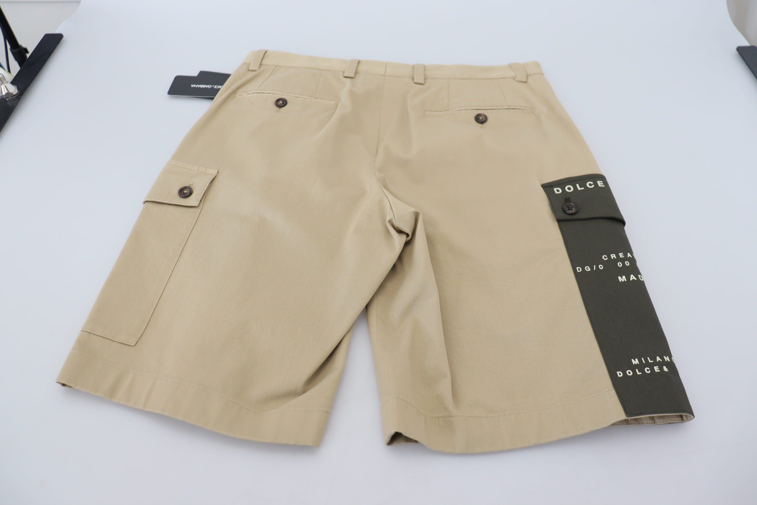 Beige cotton cargo Bermuda shorts by Dolce & Gabbana, with multiple pockets and a relaxed fit, displayed on a neutral background.