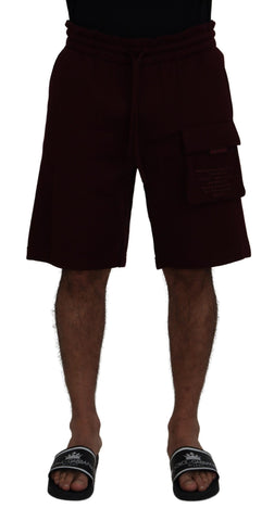 Maroon Dolce & Gabbana men's Bermuda cargo shorts with multiple pockets and a relaxed fit on a plain background.