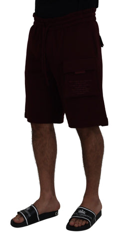 Maroon Dolce & Gabbana Bermuda cargo shorts for men with multiple pockets and relaxed fit, displayed on a neutral background.
