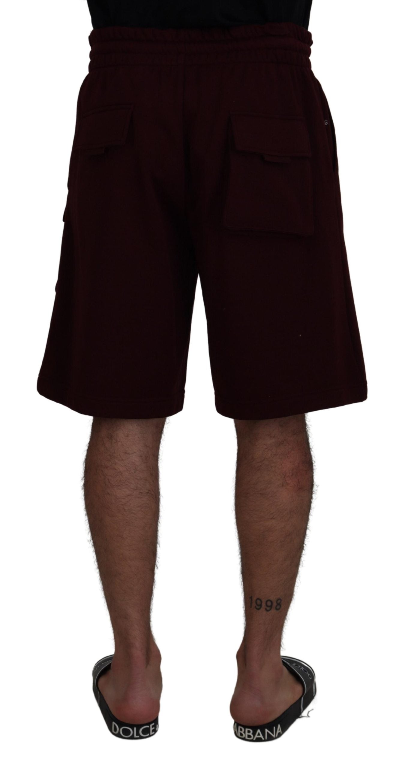 Maroon Bermuda cargo shorts for men by Dolce & Gabbana, featuring multiple pockets and a relaxed fit.