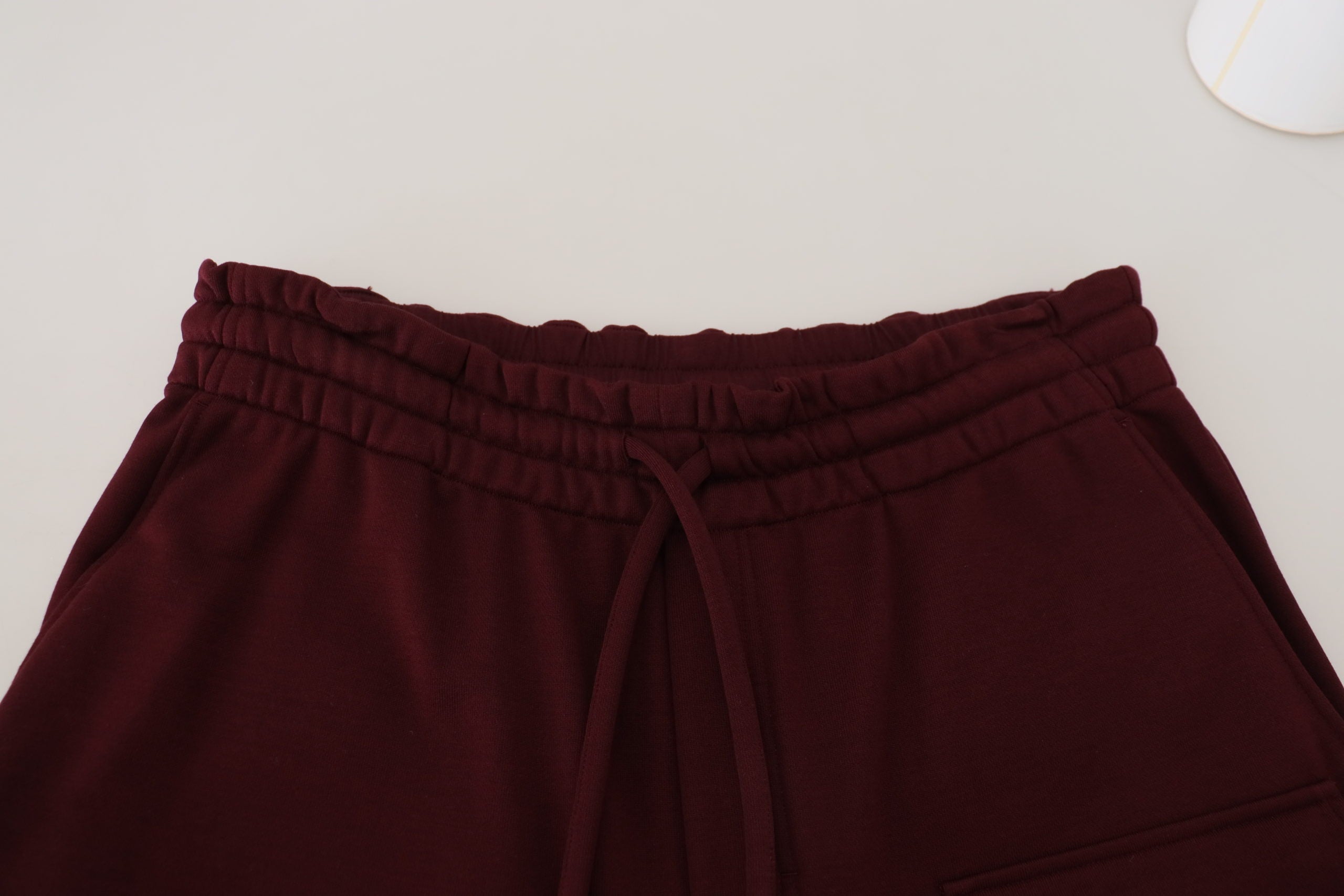 Maroon Bermuda cargo shorts for men by Dolce & Gabbana, featuring multiple pockets and a relaxed fit.