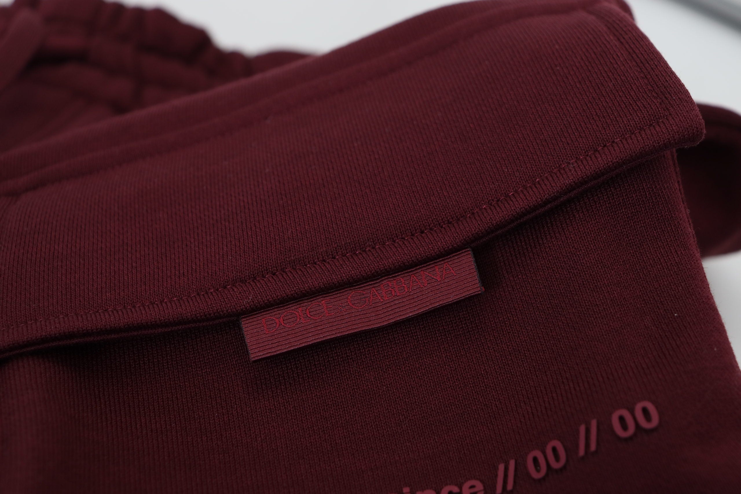Maroon Dolce & Gabbana men's Bermuda cargo shorts with multiple pockets and relaxed fit, displayed on a neutral background.