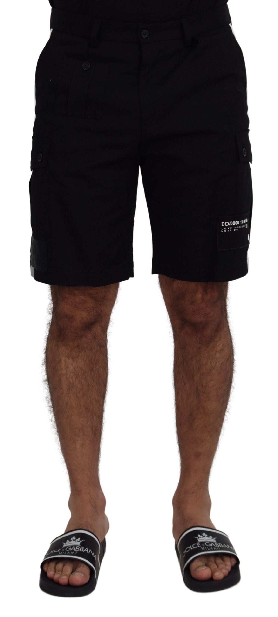 Black Bermuda cargo shorts by Dolce & Gabbana with multiple pockets and casual fit, displayed on a clothing hanger.
