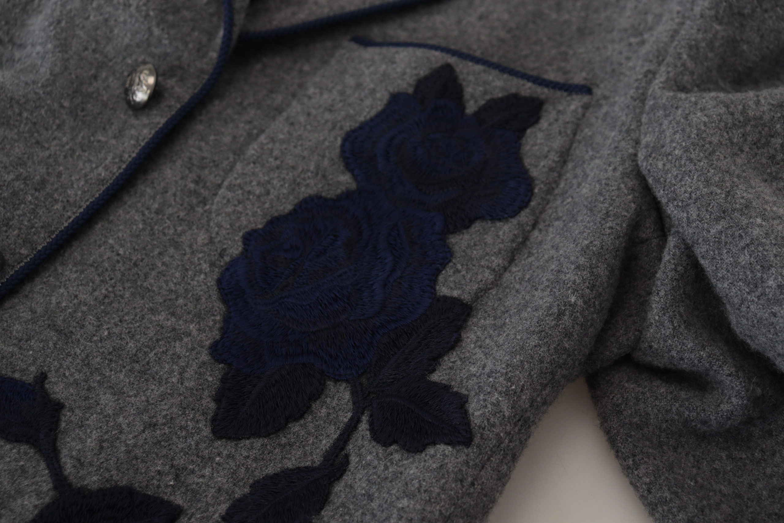 Gray wool blazer with rose embroidery, slim fit Dolce & Gabbana jacket featuring tailored design and classic lapel collar.