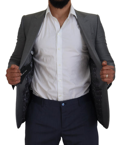 Gray wool and silk slim fit blazer jacket by Dolce & Gabbana, shown on a hanger with detailed fabric texture.