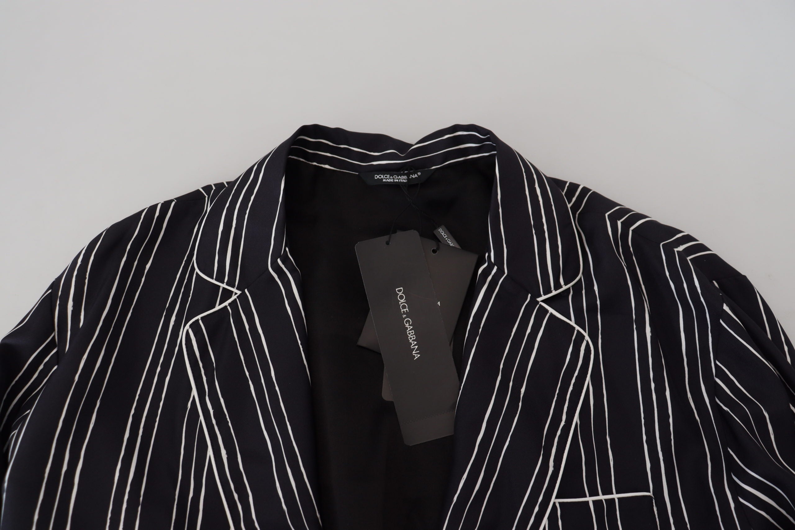 Blue striped silk pajama shirt jacket from Dolce & Gabbana, featuring a relaxed fit and elegant design, displayed on a hanger.