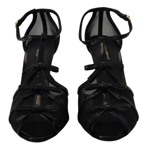 Black stiletto high heel sandals by Dolce & Gabbana with sleek straps and pointed toe, stylish footwear for formal occasions.
