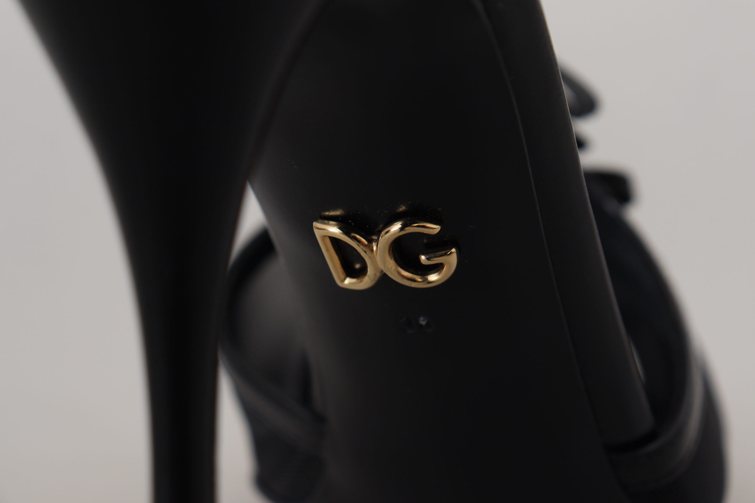 Black Dolce & Gabbana stiletto high heel sandals with thin straps and pointed toes, stylish footwear for elegant occasions.