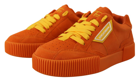 Orange leather P.J. Tucker sneakers by Dolce & Gabbana with white sole and logo detail, displayed on a plain background.