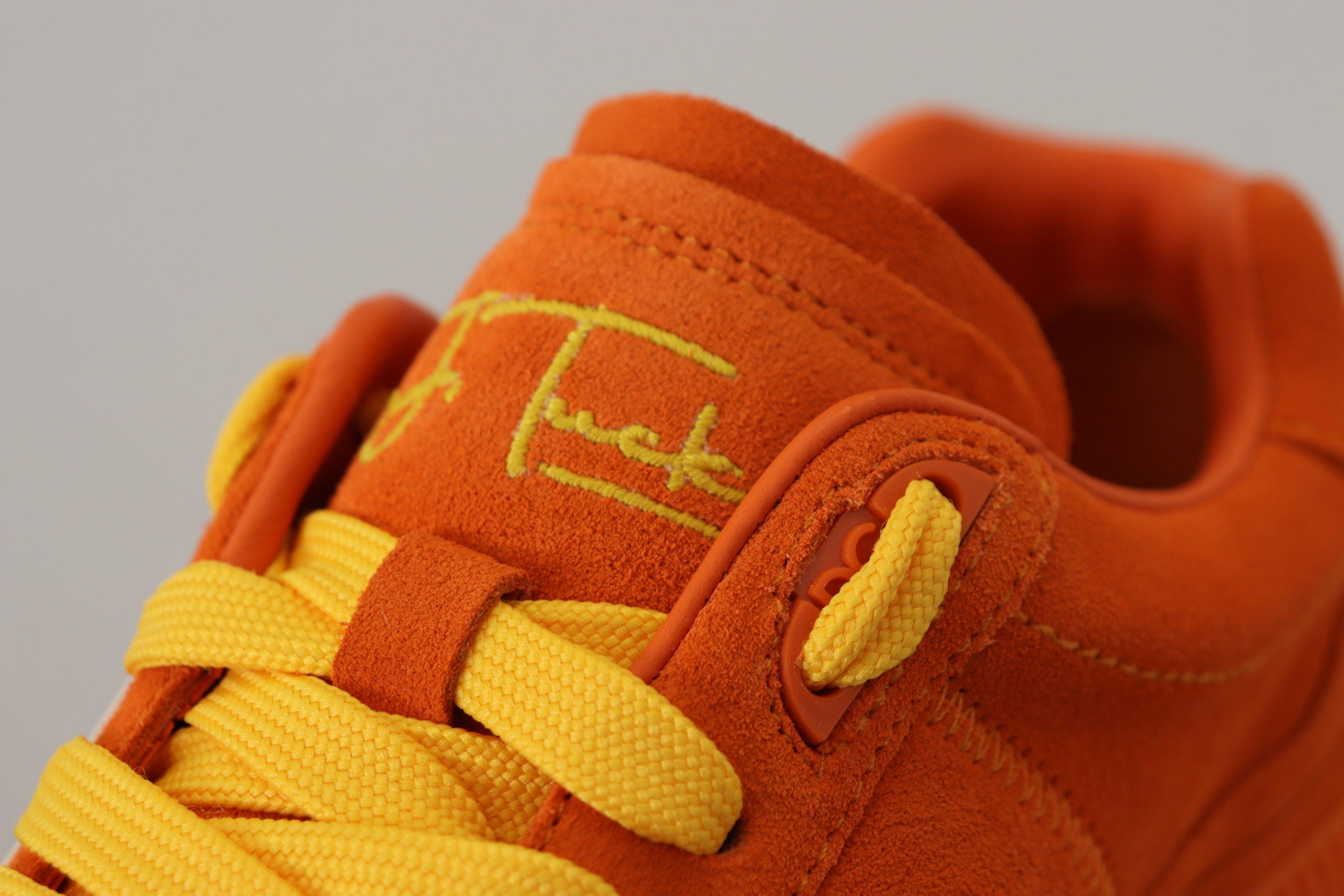 Orange leather P.J. Tucker sneakers by Dolce & Gabbana with white soles and stylish design.