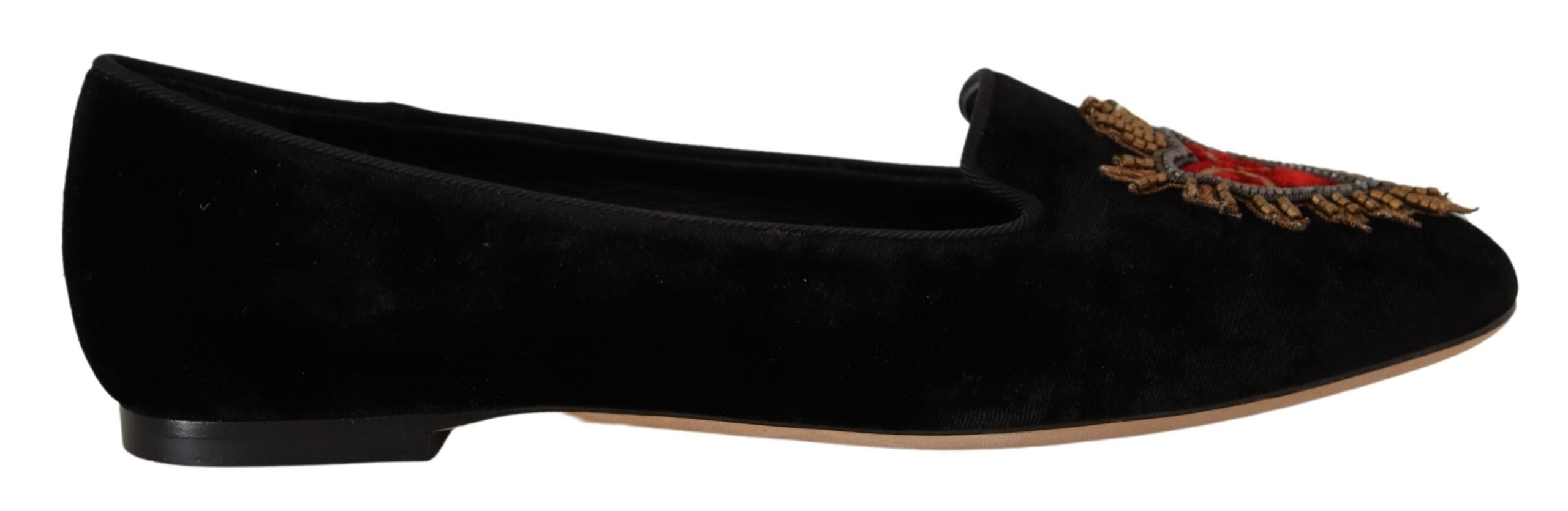 Black Dolce & Gabbana Sacred Heart patch slip-on flat shoes with decorative embellishments and comfortable design.