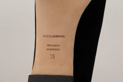 Black Dolce & Gabbana Sacred Heart patch slip-on flat shoes with decorative detailing and comfortable slip-on design.