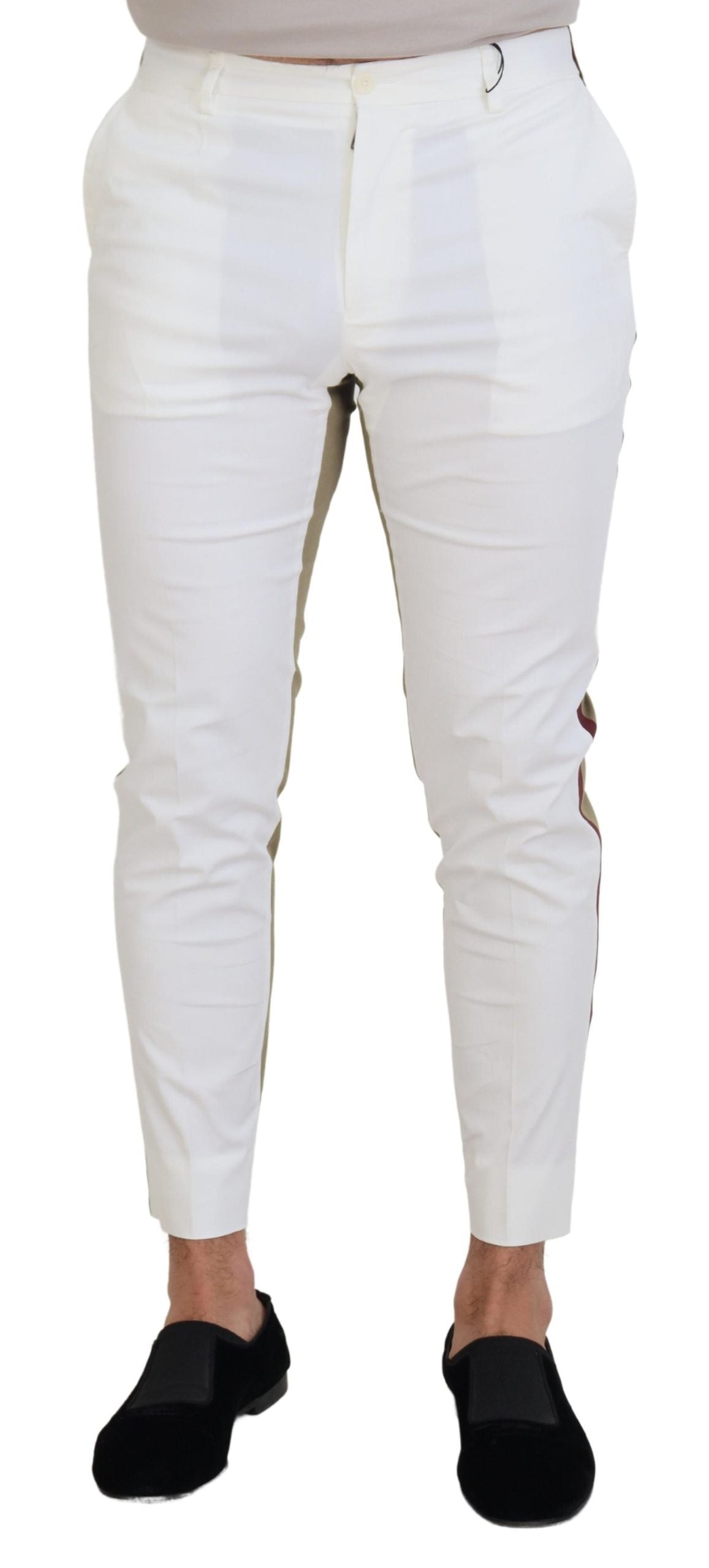 White and brown slim fit chino pants by Dolce & Gabbana, shown on a hanger with a close-up of fabric and design details.