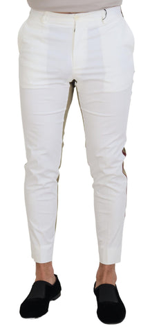White and brown slim fit chino pants by Dolce & Gabbana, shown on a hanger with a close-up of fabric and design details.