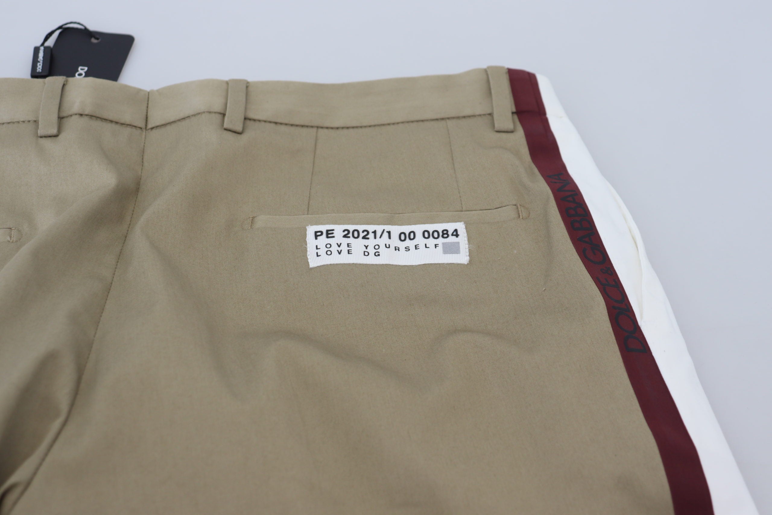 White and brown slim fit chino pants by Dolce & Gabbana, featuring a tailored design and classic style.