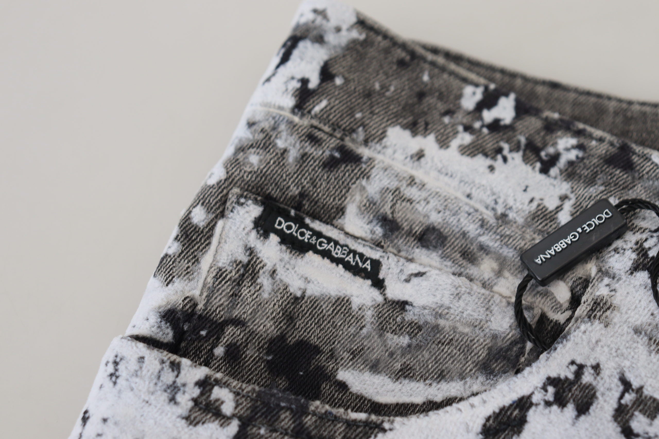 Multicolor cotton tie-dye skinny denim jeans by Dolce & Gabbana with vibrant, swirling patterns and classic five-pocket design.