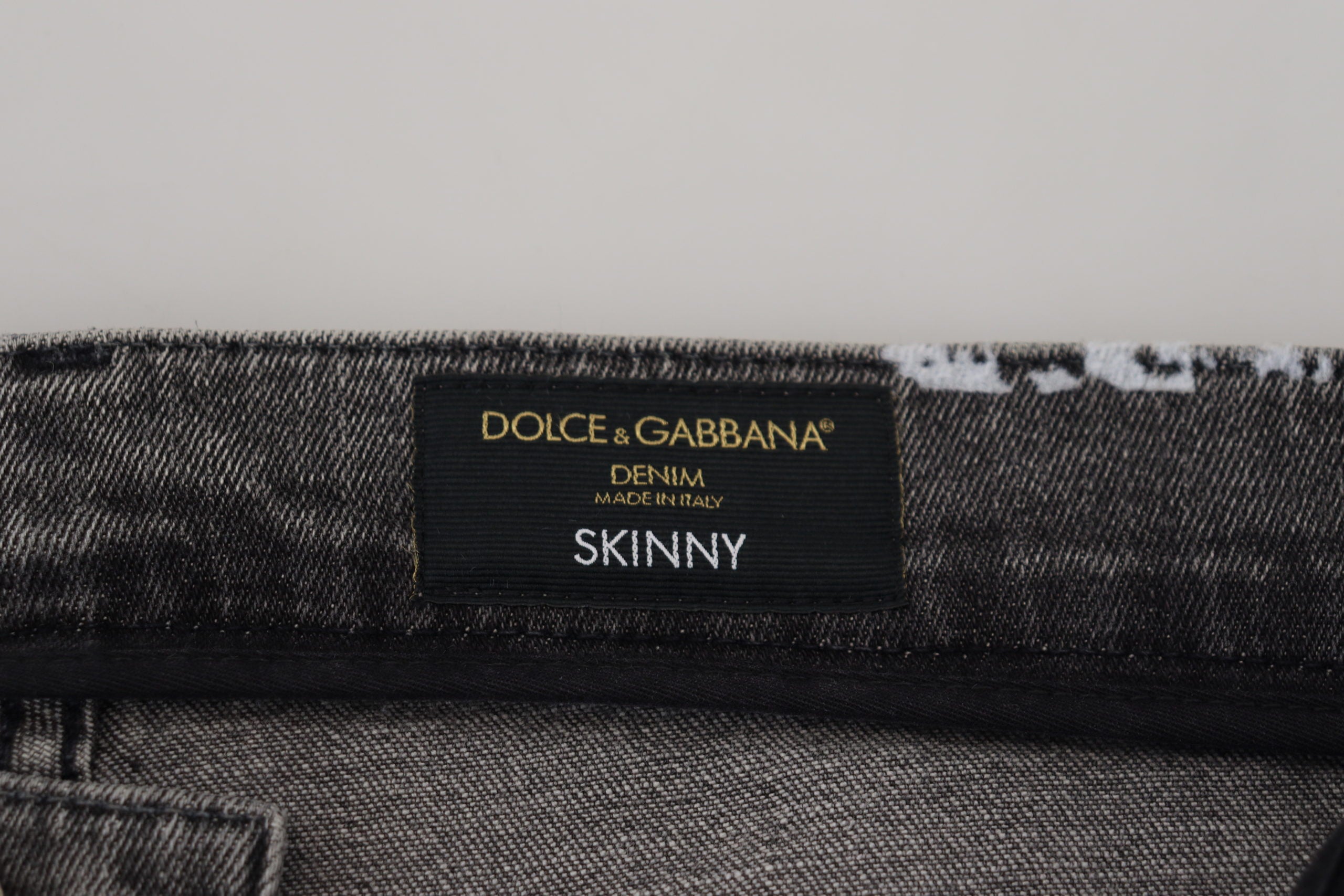 Multicolor cotton tie-dye skinny denim jeans by Dolce & Gabbana featuring vibrant, patterned fabric and classic five-pocket design.
