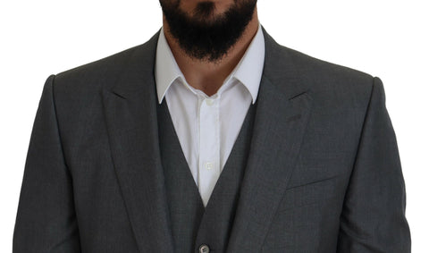 Gray Dolce & Gabbana Martini 3-piece slim fit suit displayed on a mannequin, showing tailored jacket, vest, and trousers.