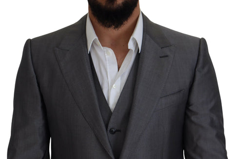 Gray Dolce & Gabbana Sicilia 3-piece slim fit suit, tailored jacket, trousers, and vest displayed on a hanger.