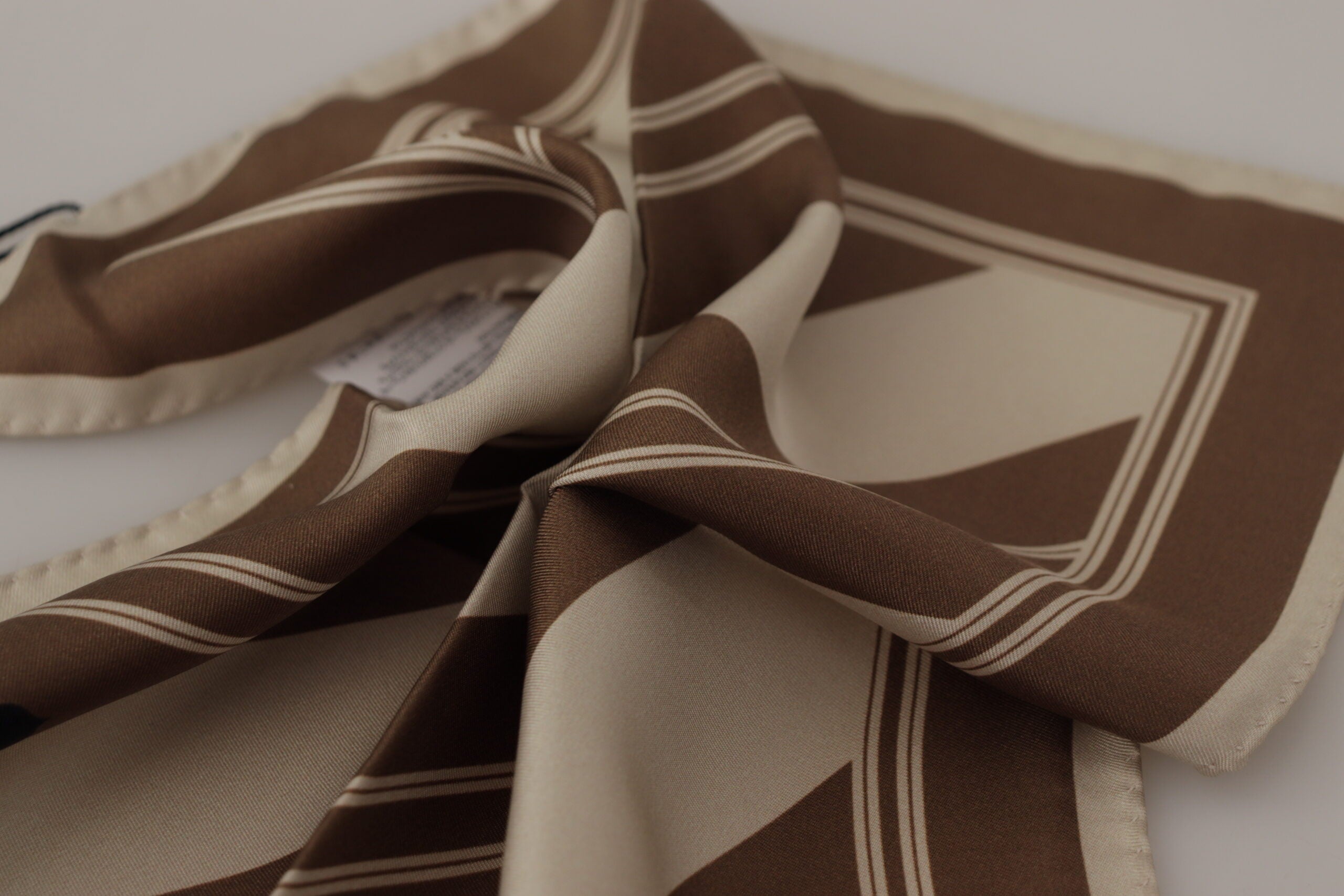 Brown and white striped Dolce & Gabbana men's square handkerchief scarf with DG logo pattern.