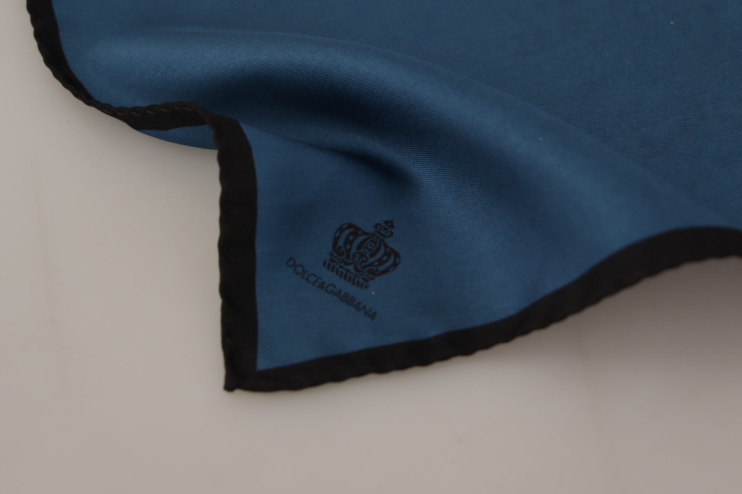 Black and blue Dolce & Gabbana square handkerchief scarf with crown print, featuring elegant patterns and soft fabric.