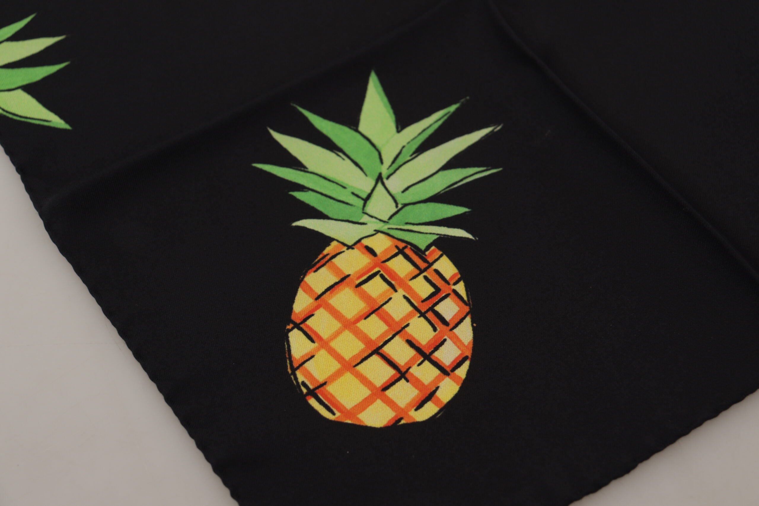 Black pineapple printed square handkerchief scarf by Dolce & Gabbana with vibrant tropical pineapple design.