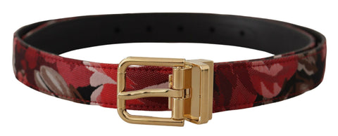Red jacquard leather belt with rose pattern and gold metal buckle by Dolce & Gabbana, shown on a plain background.