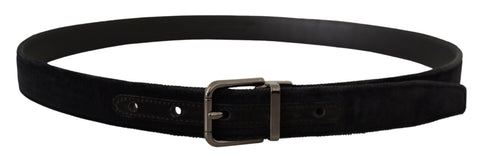 Black velvet belt with silver tone logo metal buckle by Dolce & Gabbana, shown draped with detailed close-up of buckle.