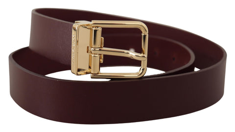 Maroon Vitello leather belt with gold metal buckle from Dolce & Gabbana, showing the textured leather and shiny buckle detail.