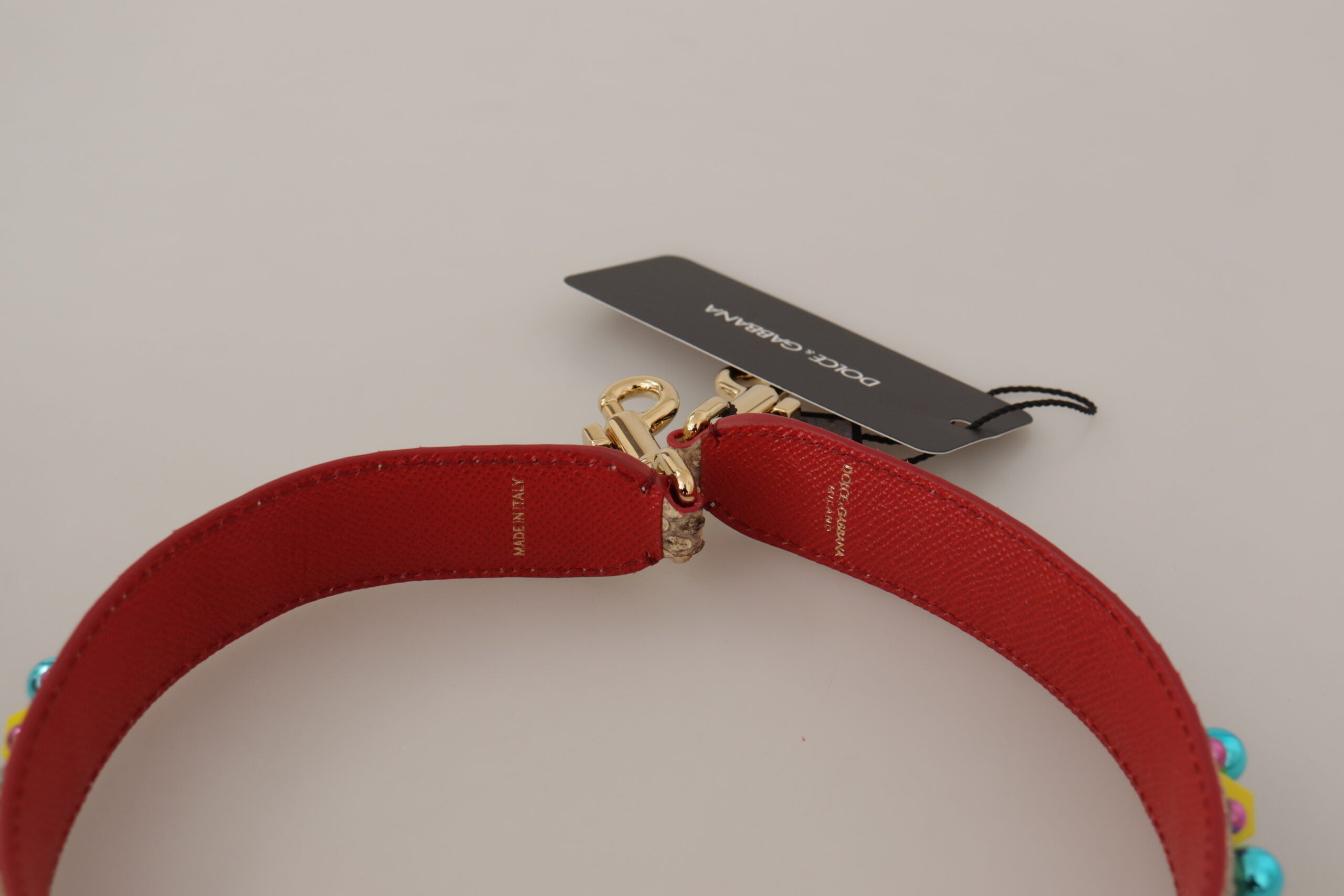 Beige python leather shoulder strap with crystal embellishments, designed by Dolce & Gabbana for stylish accessories.