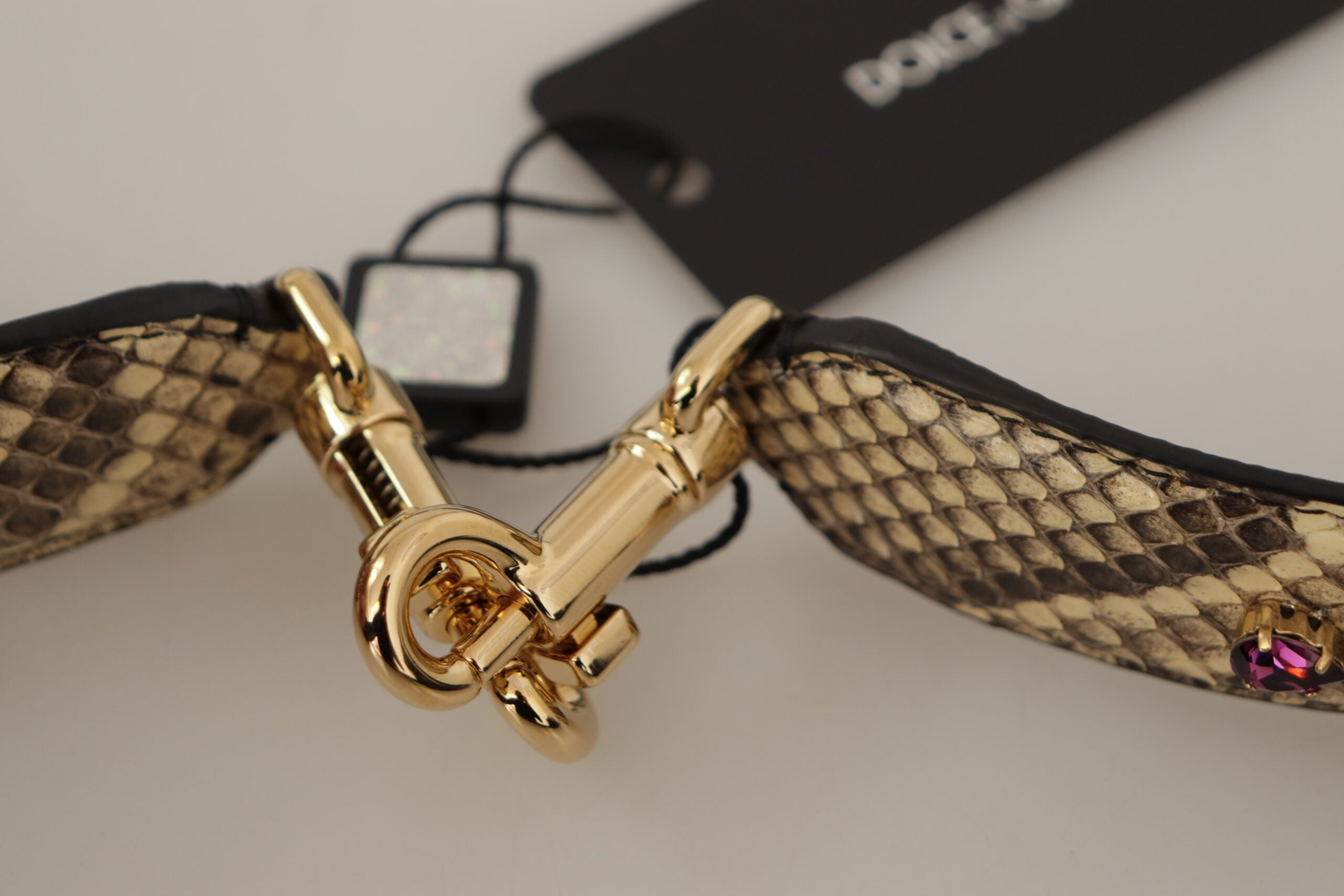 Beige exotic leather reversible shoulder strap with crystals from Dolce & Gabbana, featuring intricate detailing and polished hardware.