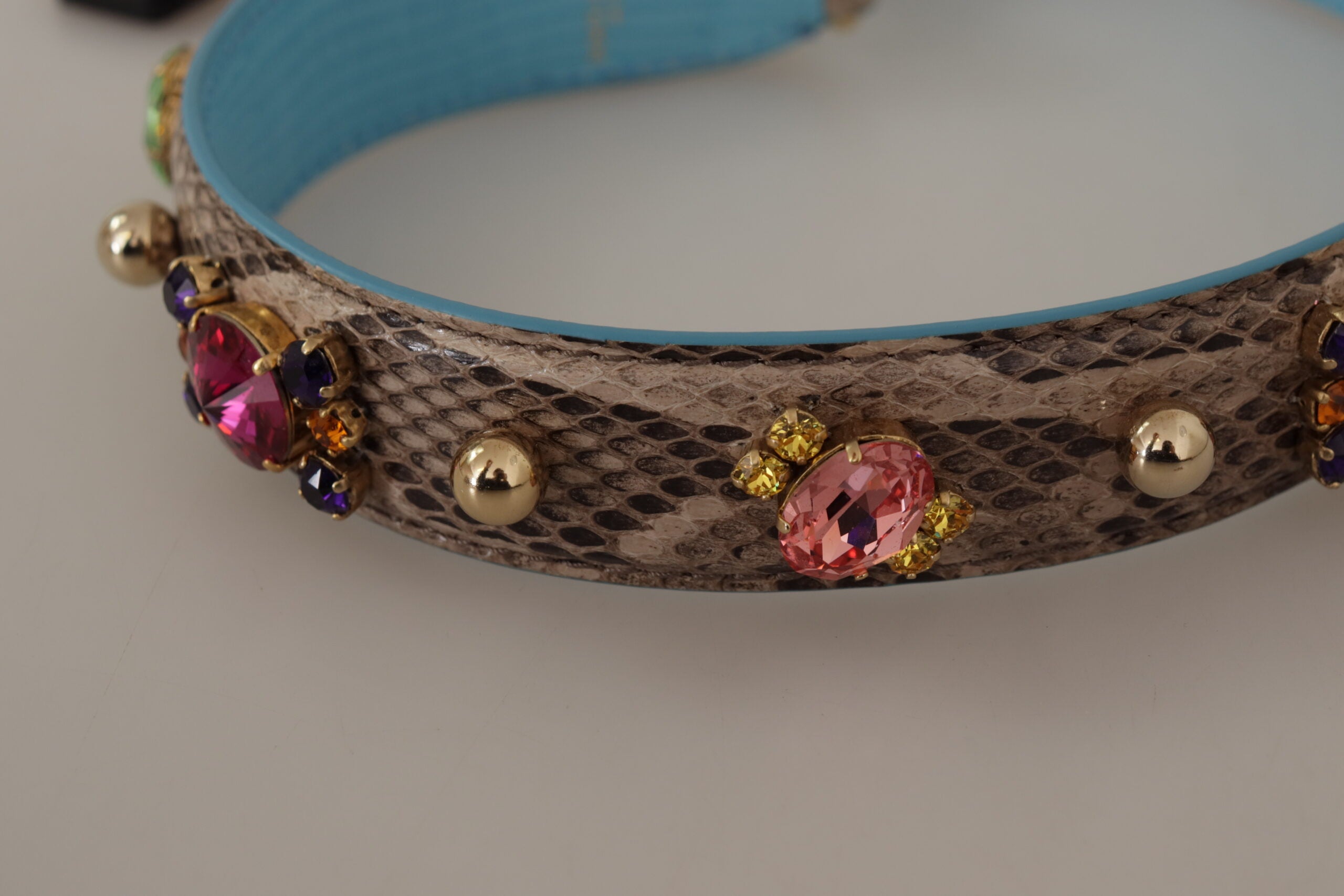 Brown exotic leather shoulder strap with crystal embellishments by Dolce & Gabbana, featuring detailed craftsmanship and luxurious texture.