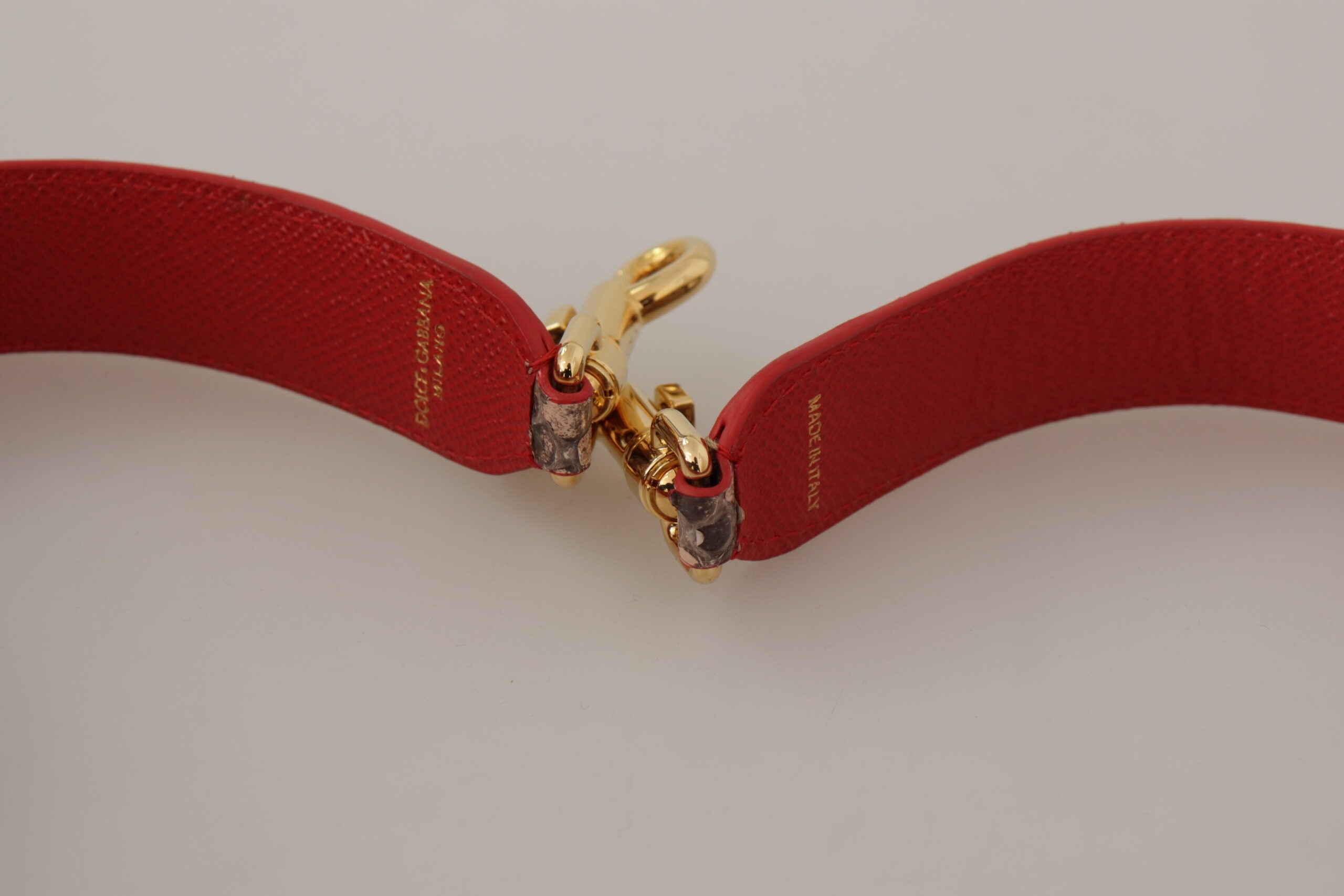 Brown Python leather shoulder strap with crystal embellishments from Dolce & Gabbana, featuring textured python skin and sparkling crystal details.