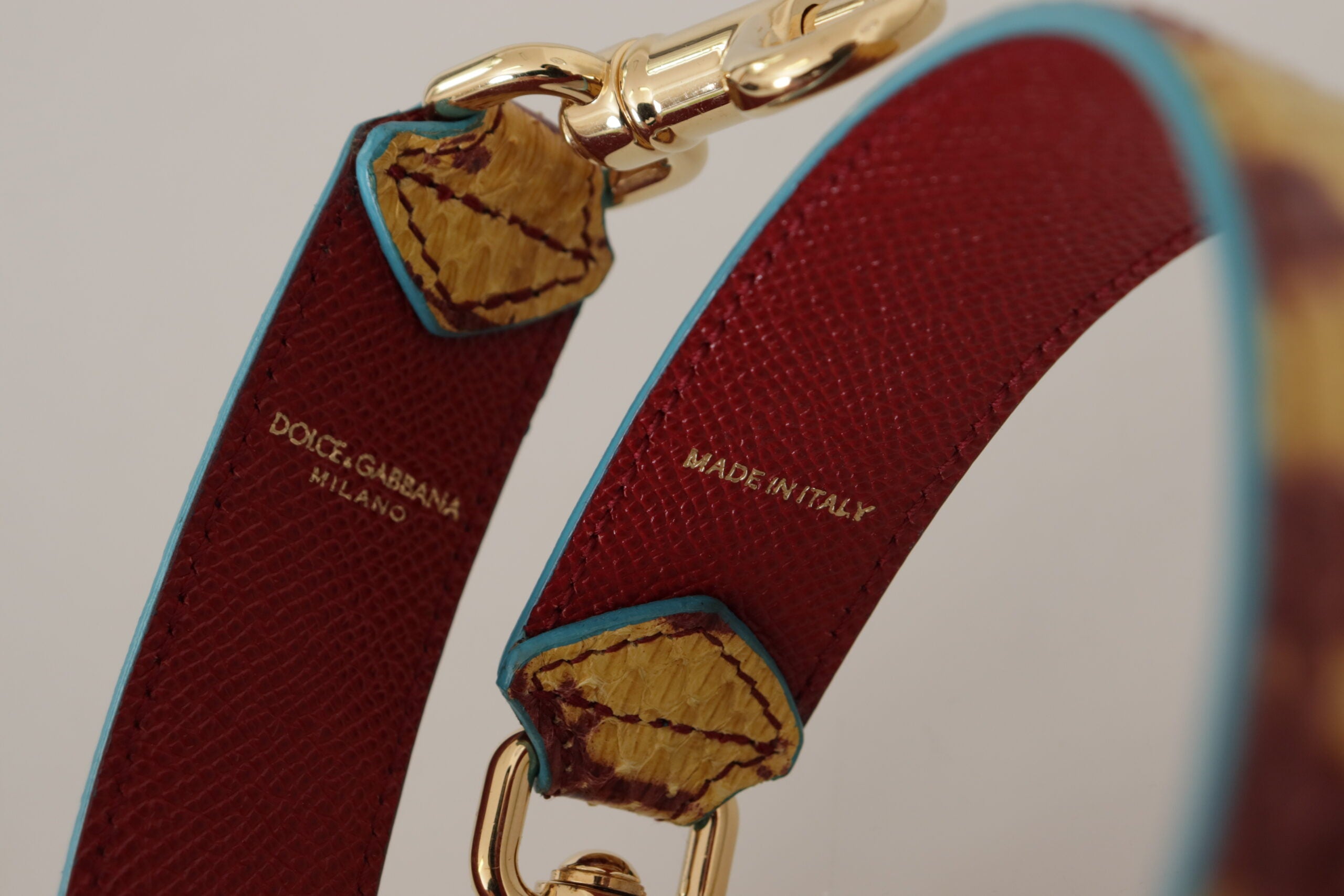 Yellow and red leather shoulder strap with gold tone hardware from Dolce & Gabbana.