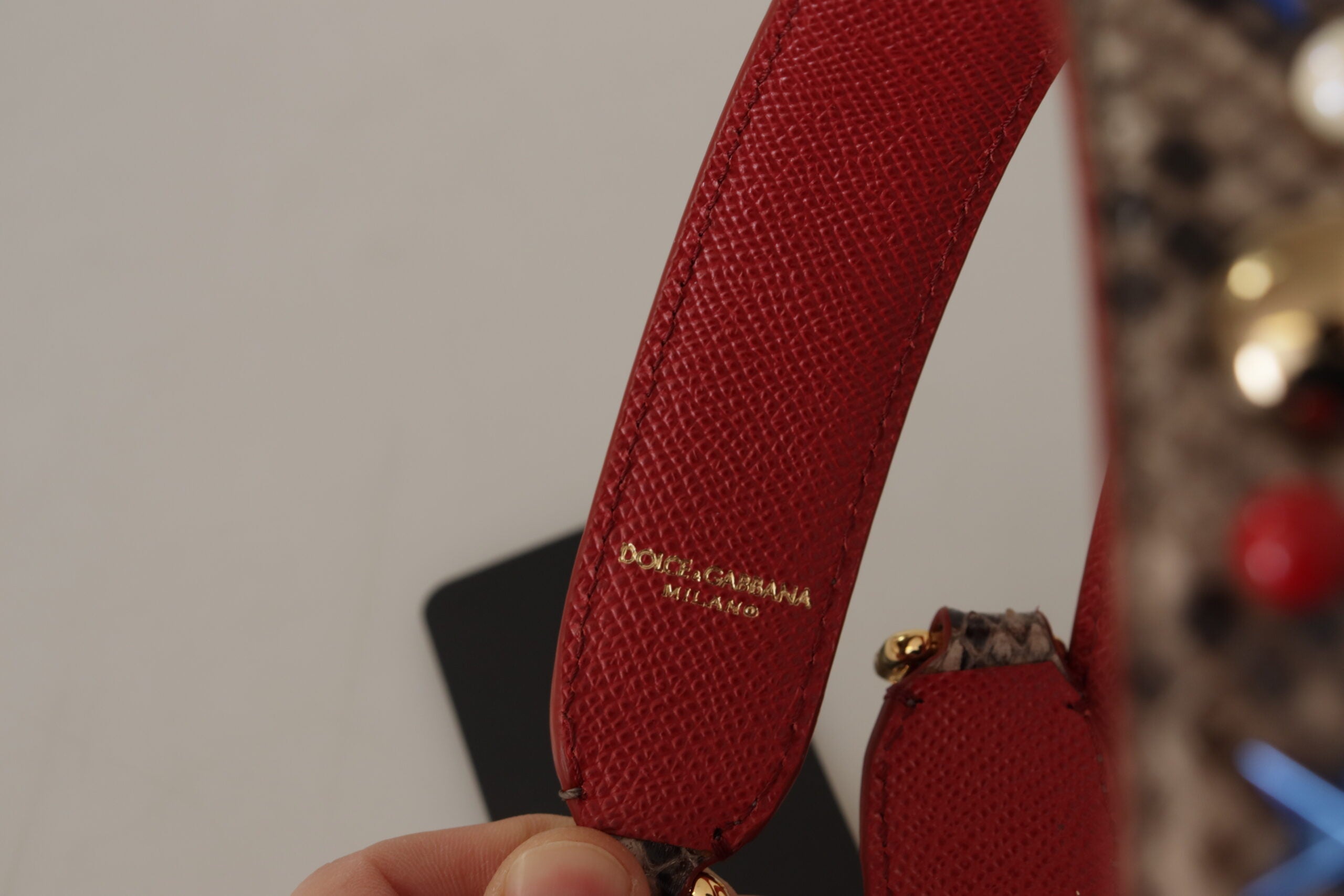 Brown Python leather shoulder strap with silver studs from Dolce & Gabbana, featuring textured python skin and metal hardware.