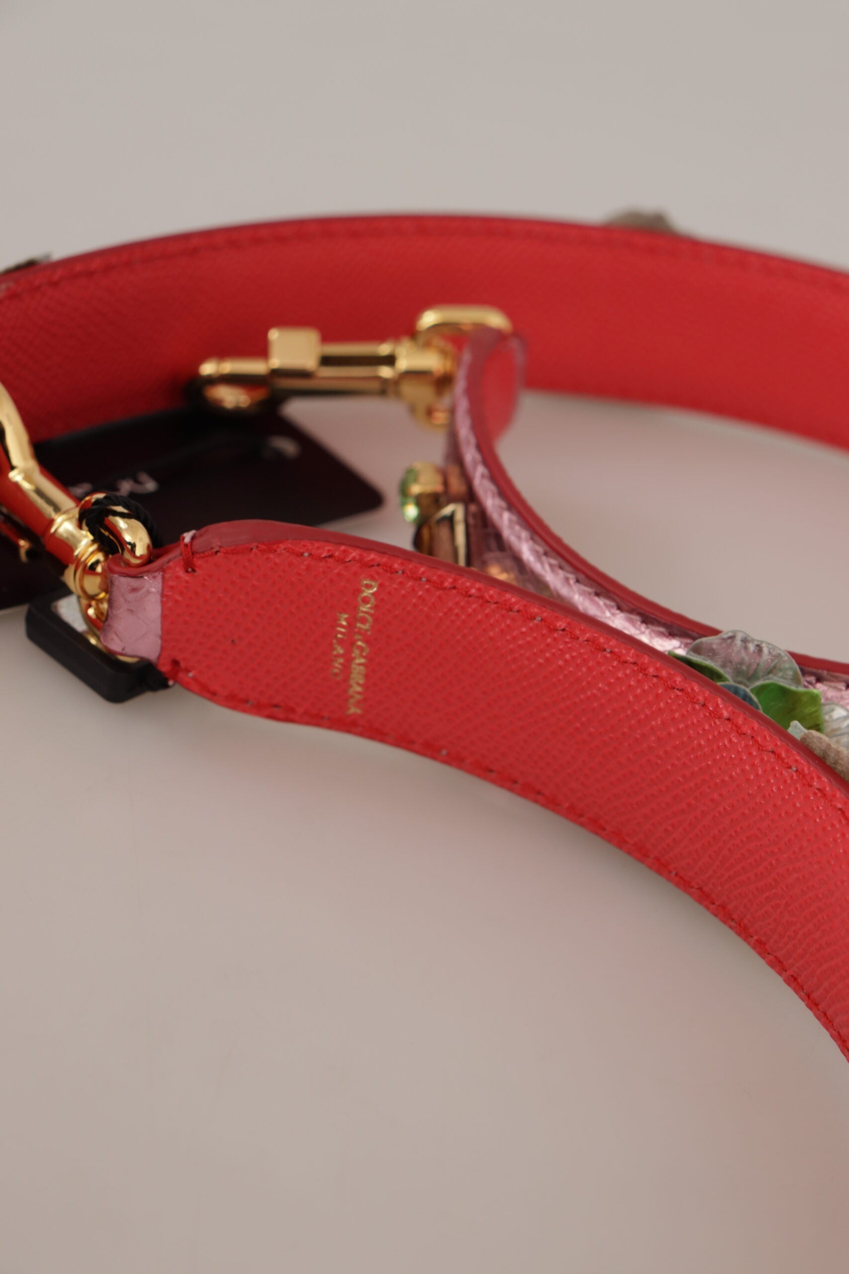 Metallic pink leather shoulder strap with studded detailing from Dolce & Gabbana, featuring adjustable length and stylish design.