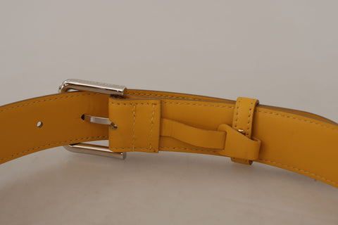 Yellow leather belt with silver tone logo metal buckle from Dolce & Gabbana, featuring a sleek, stylish design.