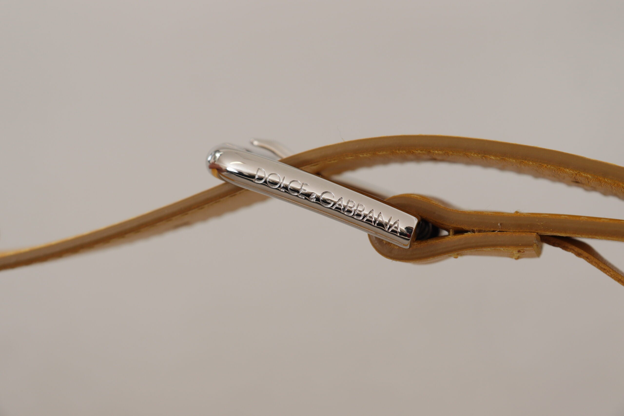 Yellow leather belt with silver-tone logo metal buckle by Dolce & Gabbana, showcasing a sleek design and polished finish.