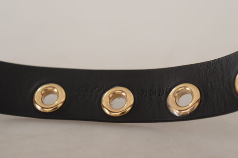Black leather belt with silver eyelet metal buckle by Dolce & Gabbana, showing close-up of the buckle and textured leather strap.