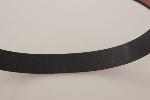 Red leather belt by Dolce & Gabbana with a gold logo engraved metal buckle, stylish accessory with a sleek design.