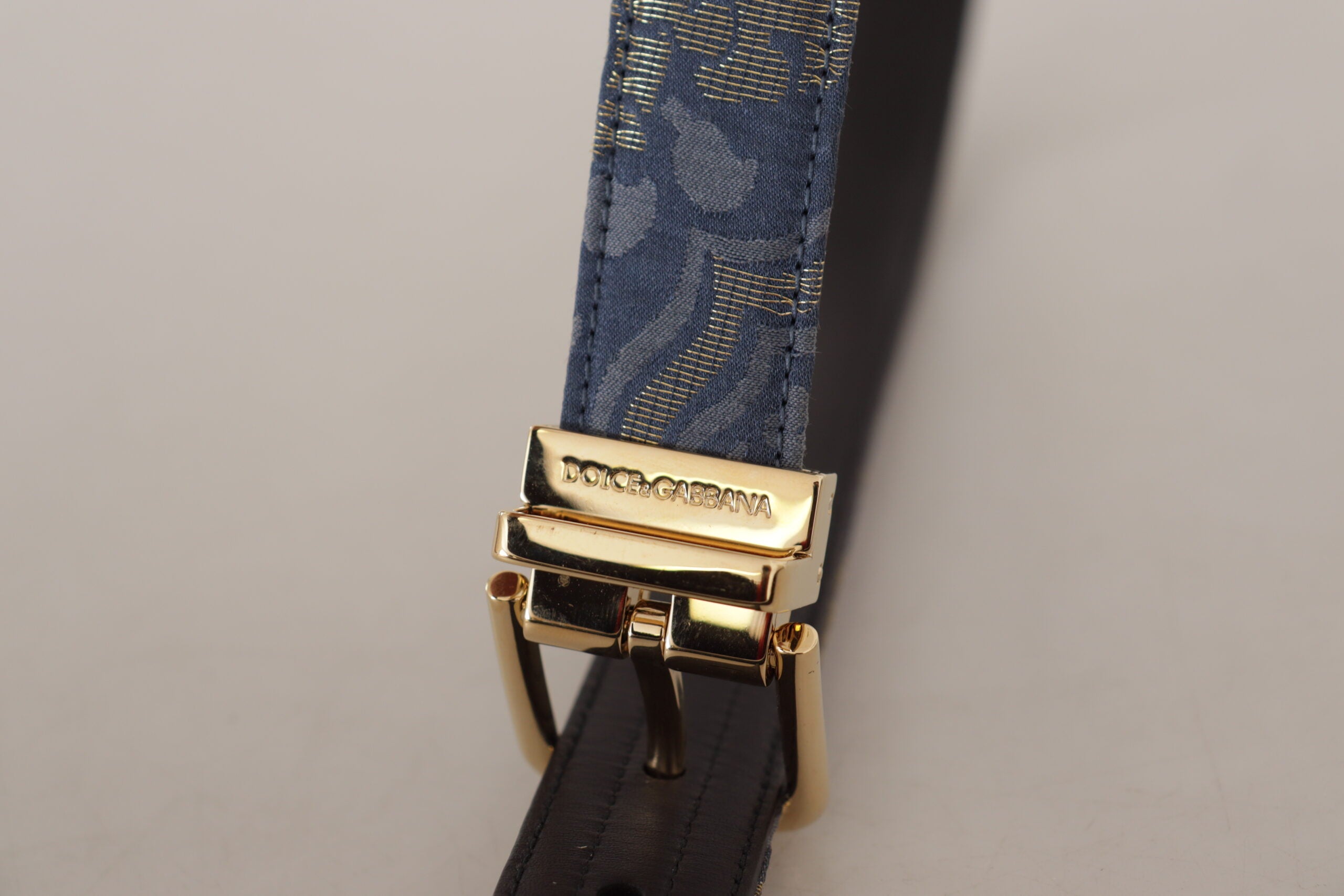 Navy blue Jacquard belt with gold-tone logo metal buckle from Dolce & Gabbana, detailed fabric pattern and sleek design.
