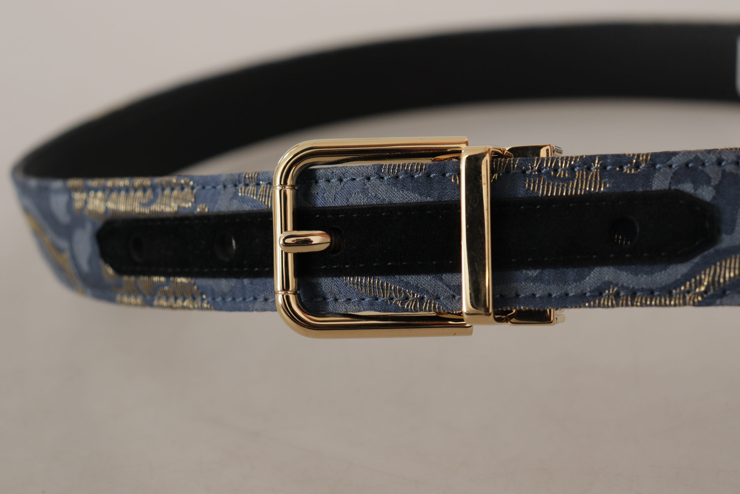 Navy blue jacquard belt with gold tone logo metal buckle from Dolce & Gabbana, showcasing intricate fabric pattern and stylish design.