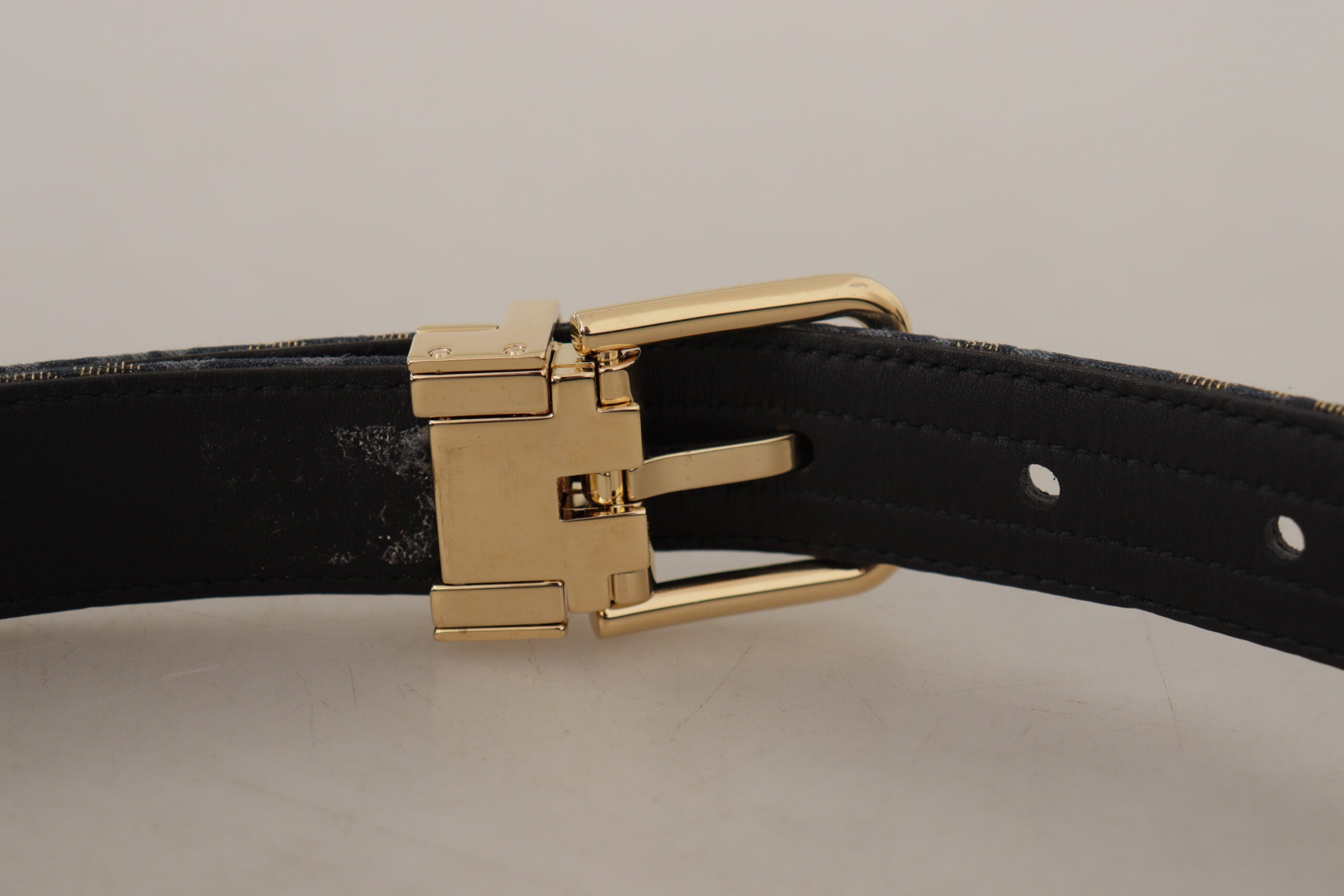 Navy blue Jacquard belt with gold-tone logo metal buckle from Dolce & Gabbana, stylish accessory with intricate woven pattern.