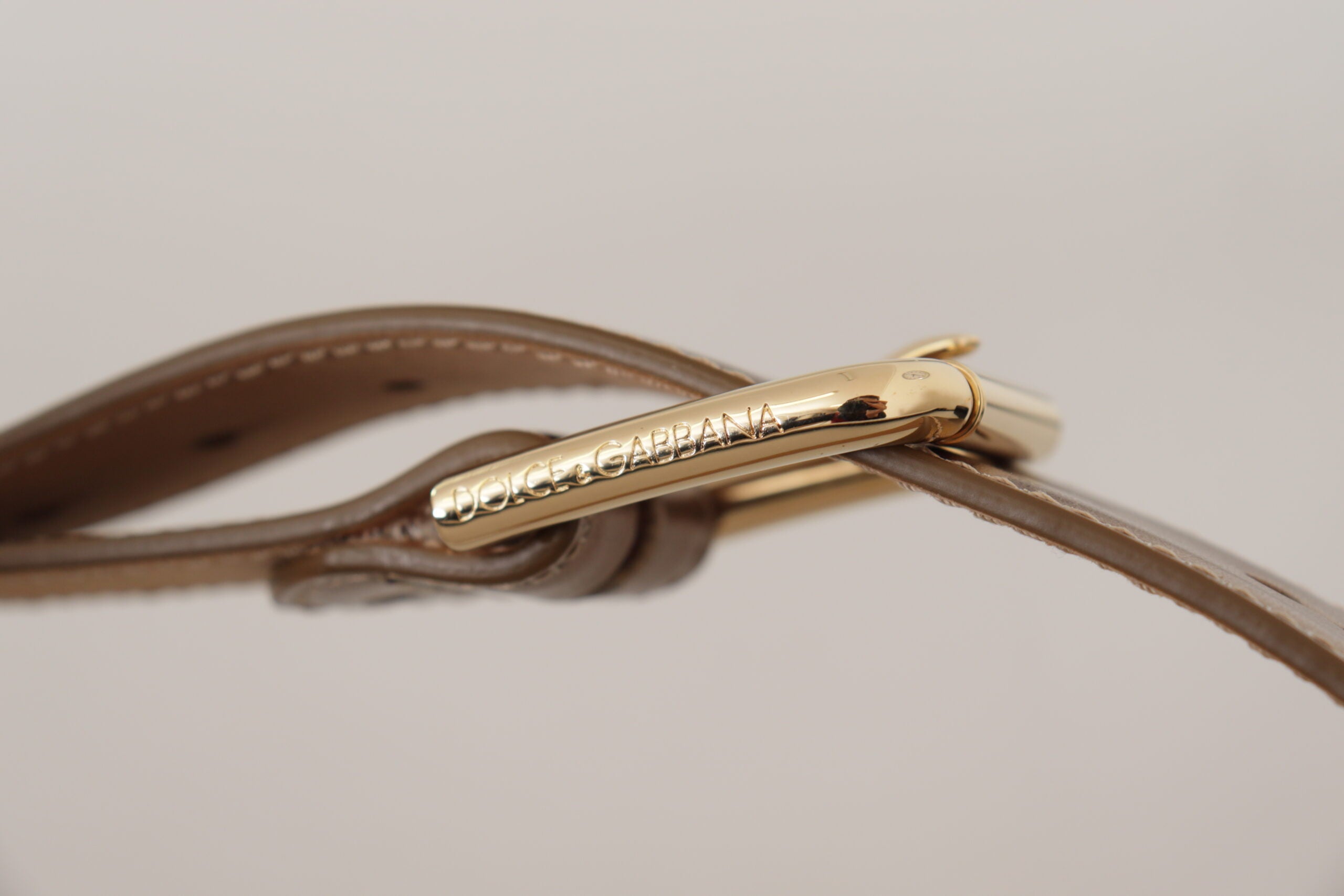 Bronze calf leather waist belt with gold logo buckle from Dolce & Gabbana, featuring a sleek, stylish design.