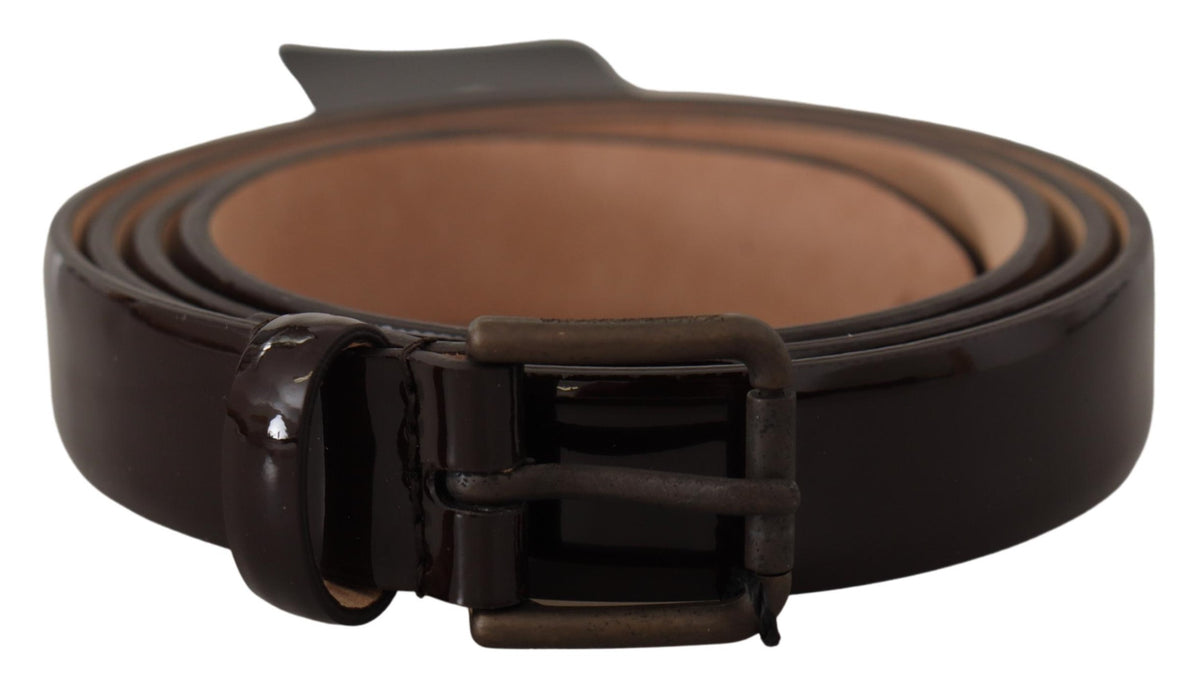 Black patent leather waist belt with Dolce & Gabbana logo metal buckle, stylish accessory with sleek finish and modern design.