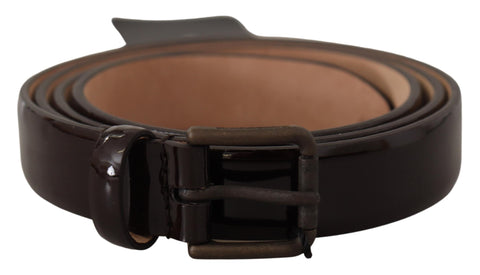 Black patent leather waist belt with Dolce & Gabbana logo metal buckle, stylish accessory with sleek finish and modern design.