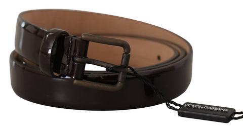 Black patent leather belt by Dolce & Gabbana with a metal logo waist buckle, showcasing sleek and shiny finish.