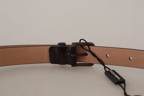 Black patent leather Dolce & Gabbana belt with a metal logo waist buckle, featuring sleek and shiny design.