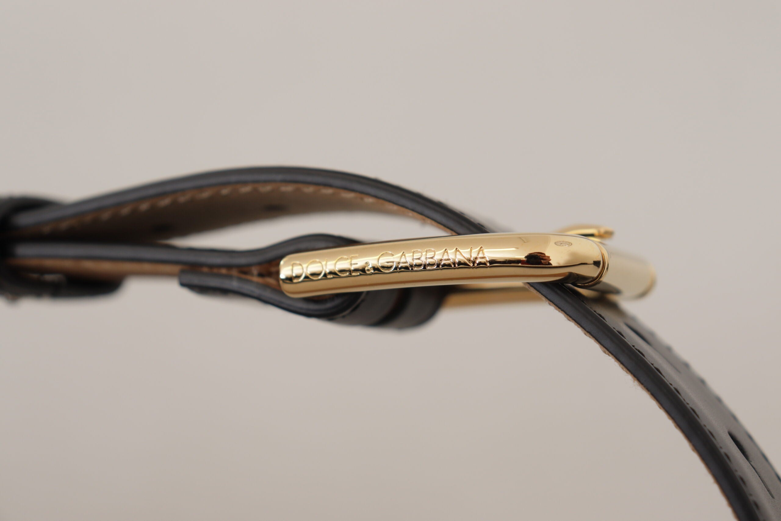 Black solid leather belt with a gold waist buckle from Dolce & Gabbana, featuring a classic design and smooth finish.
