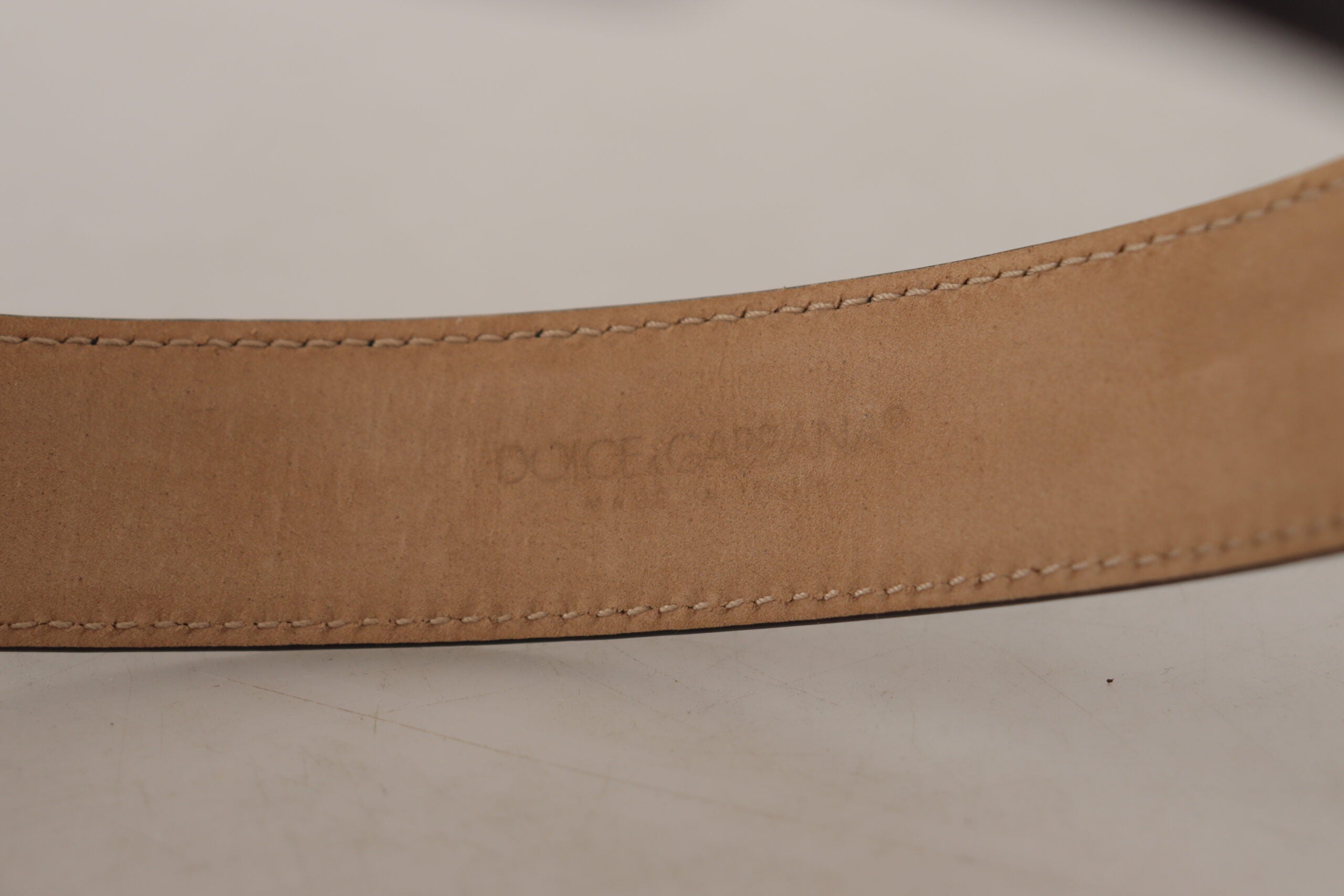 Black solid leather waist belt with classic gold buckle from Dolce & Gabbana, featuring a sleek and timeless design.